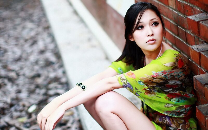 woman in green dress sitting