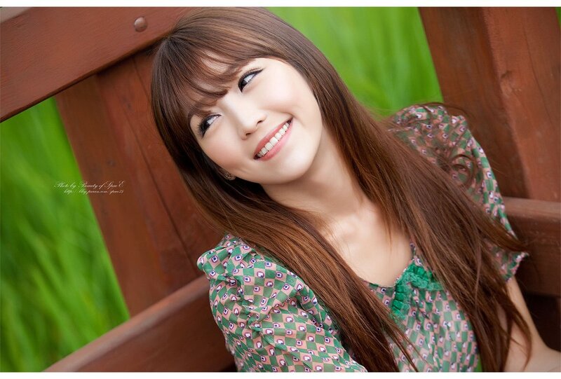 woman in green dress smiling