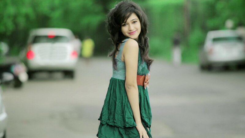 woman in green dress smiling