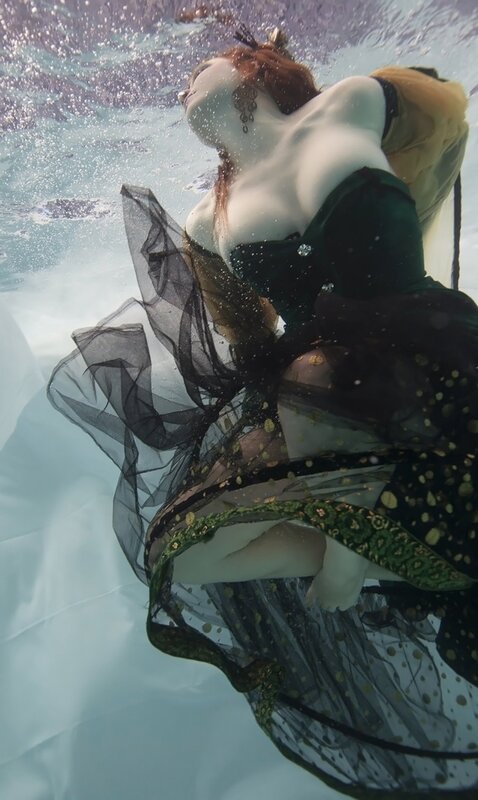 woman in green dress underwater