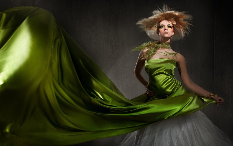 woman in green dress with flowing fabric