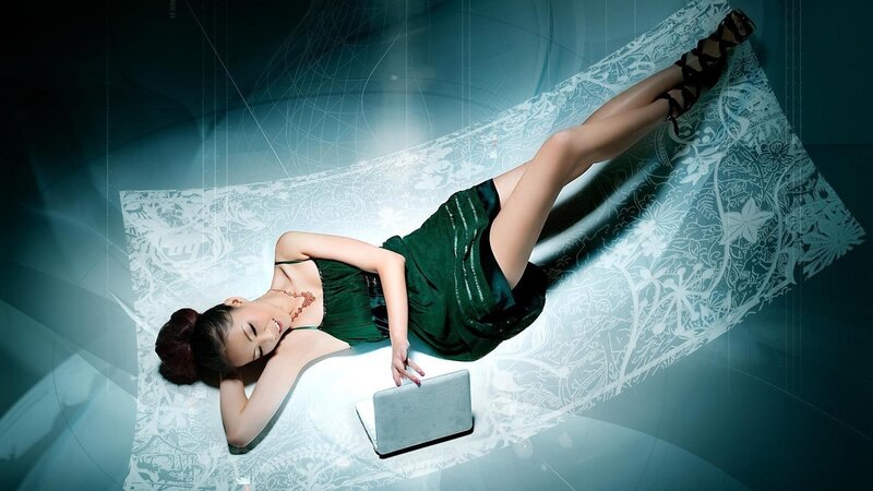 woman in green dress with laptop