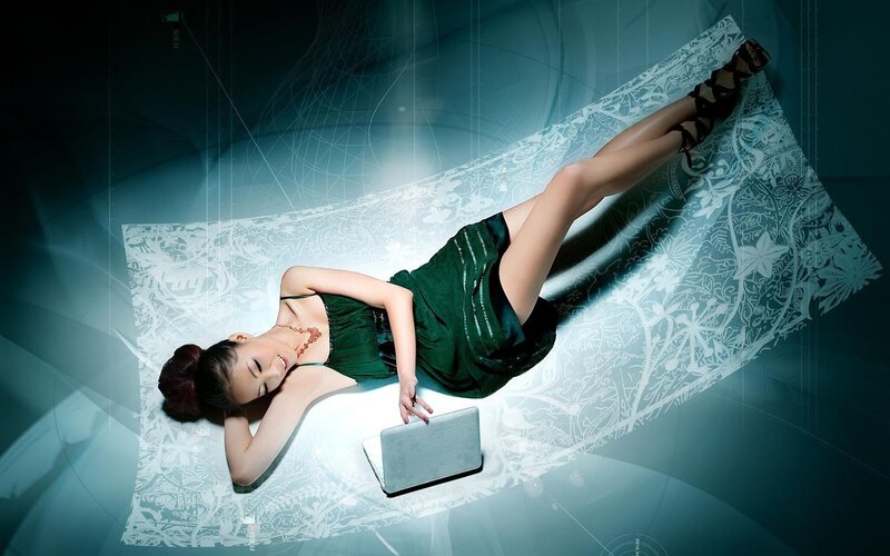 Woman in green dress with laptop