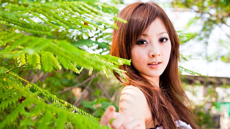 woman in green foliage