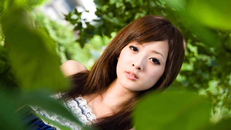 woman in green foliage