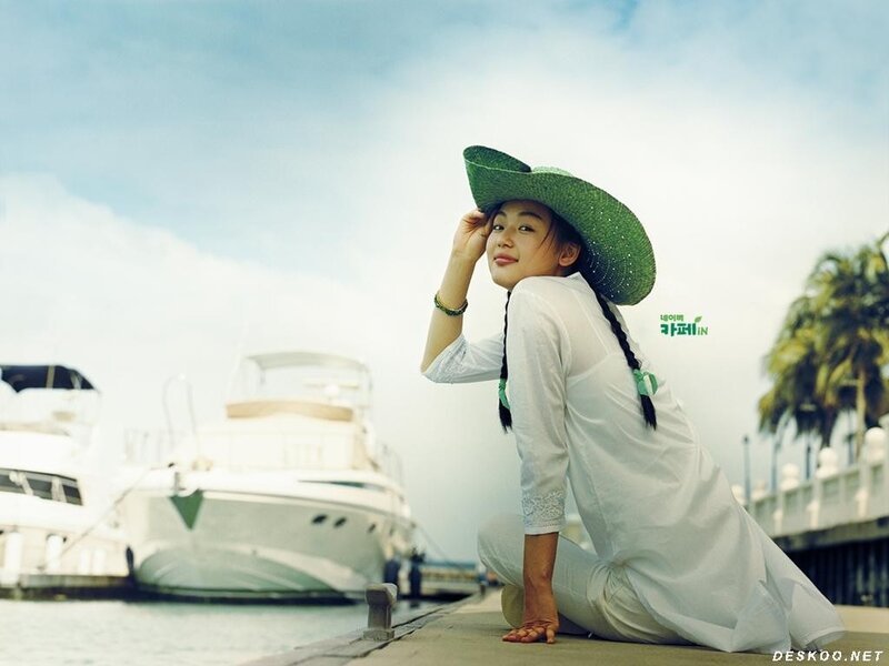 Woman in green hat at marina