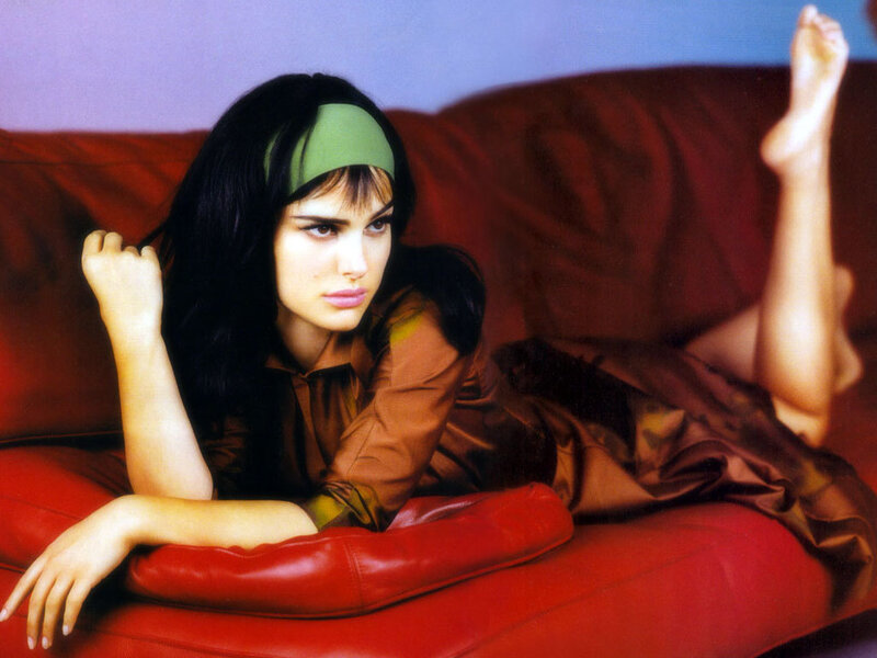 woman in green headband on red couch