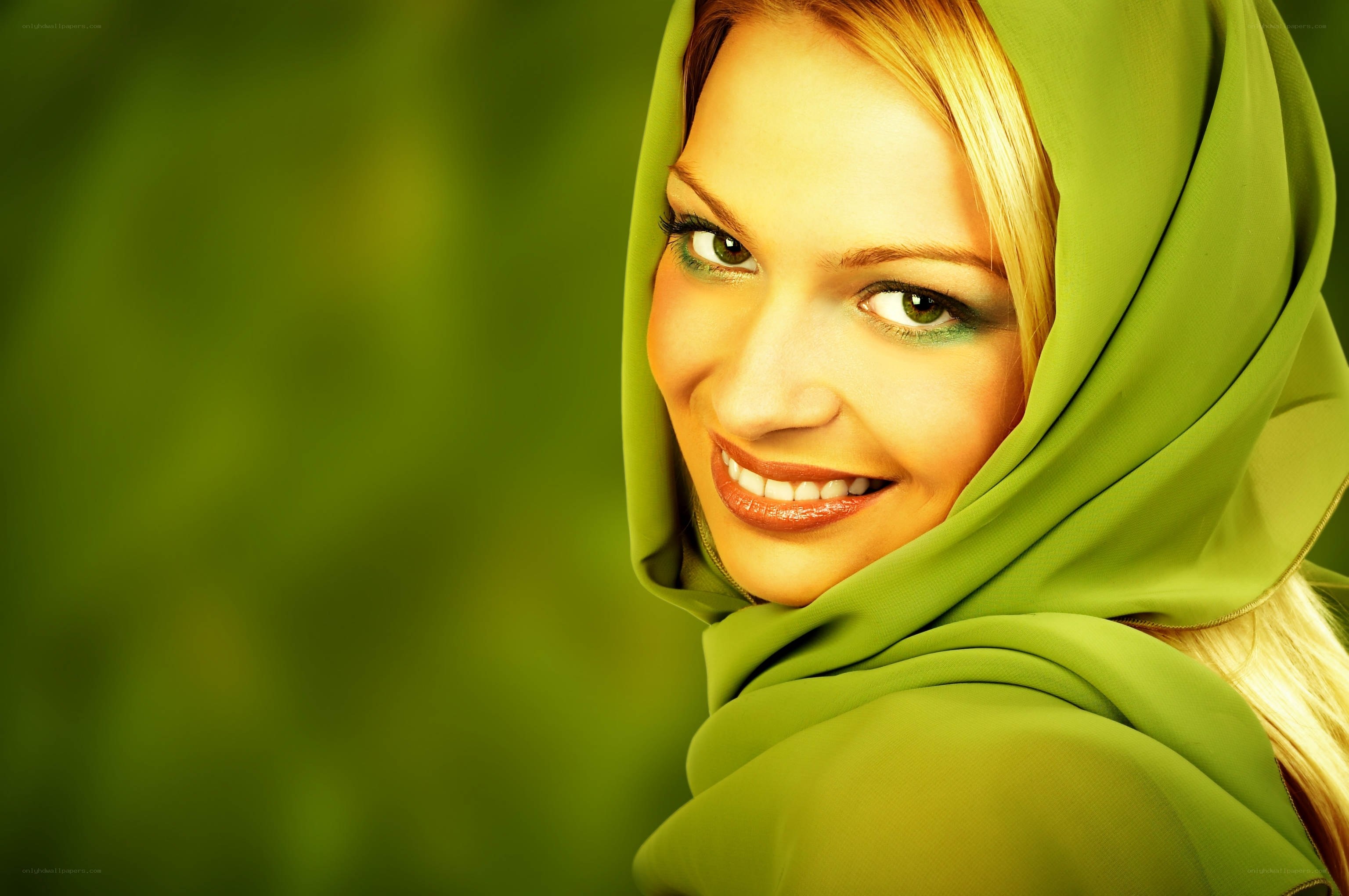 woman in green hijab smiling