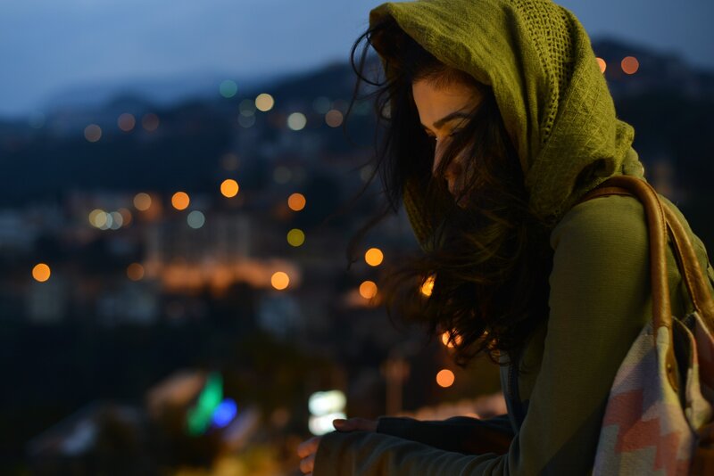 woman in green hoodie at dusk