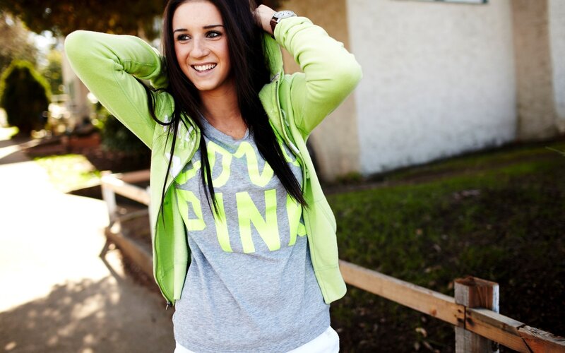 woman in green hoodie smiling
