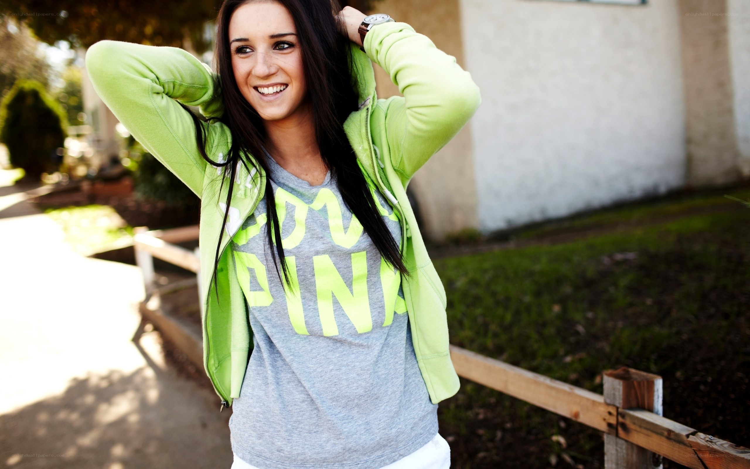 woman in green hoodie smiling