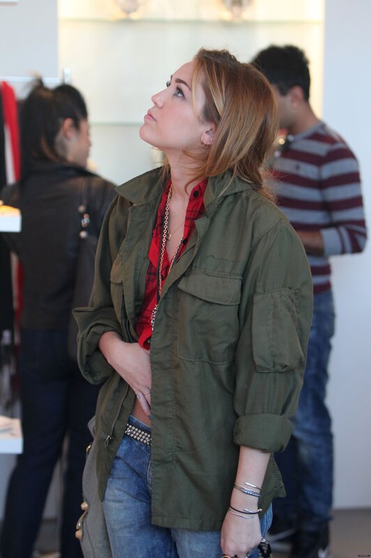 woman in green jacket looking up