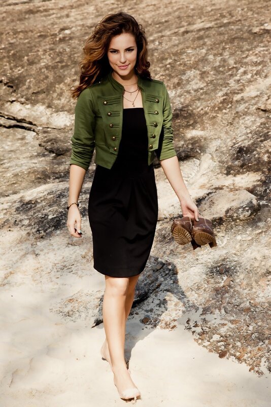 Woman in green jacket on beach