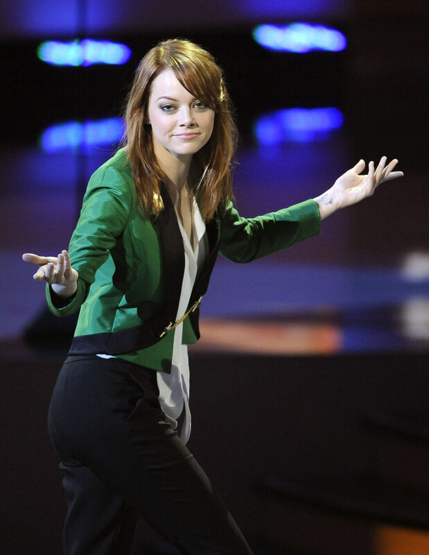 Woman in green jacket on stage
