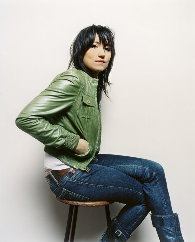 woman in green jacket sitting