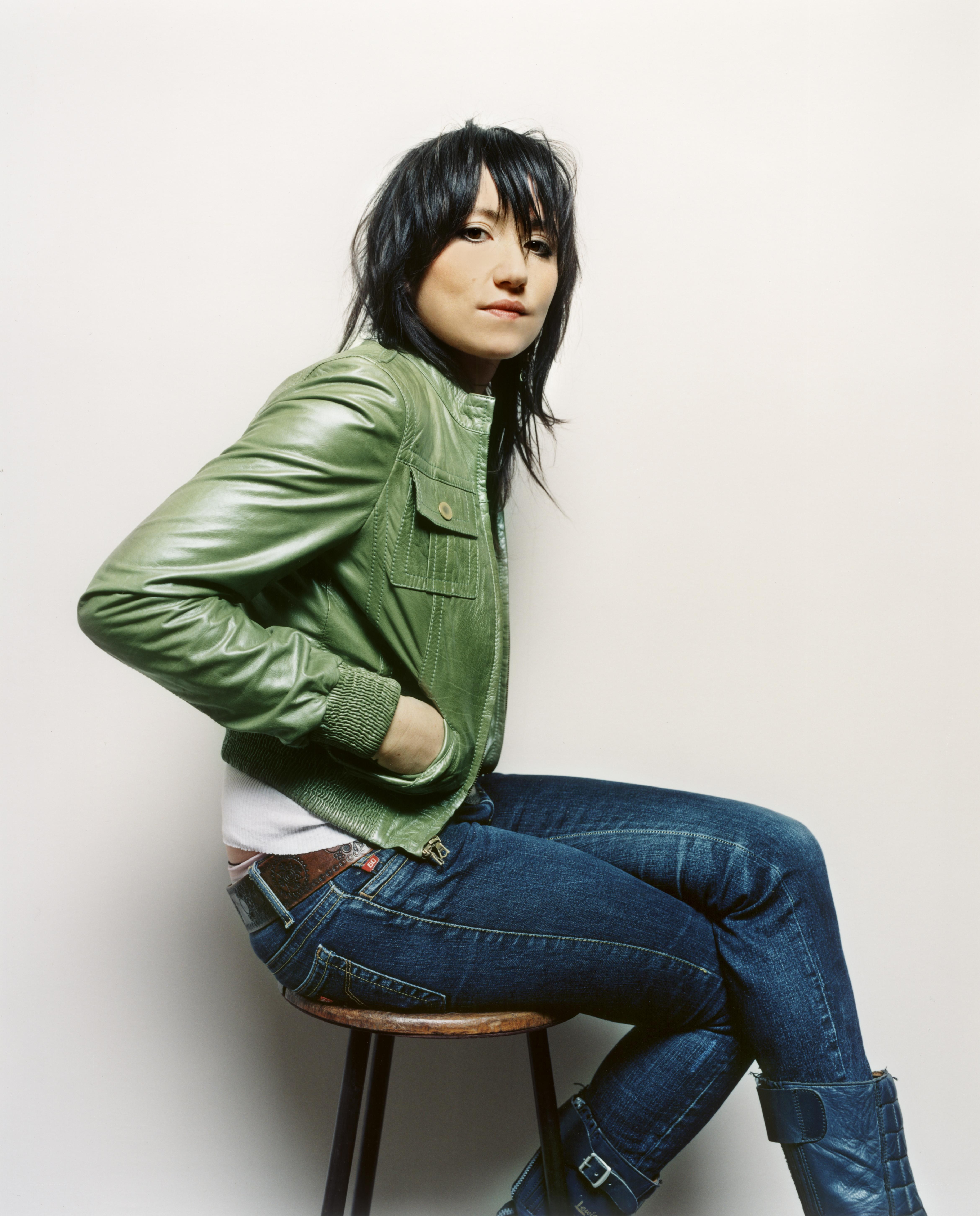 woman in green jacket sitting