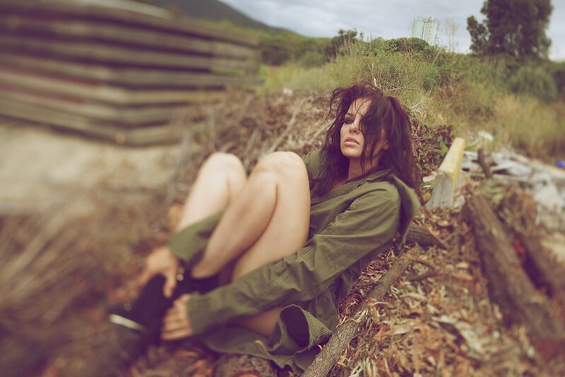 woman in green jacket sitting outdoors