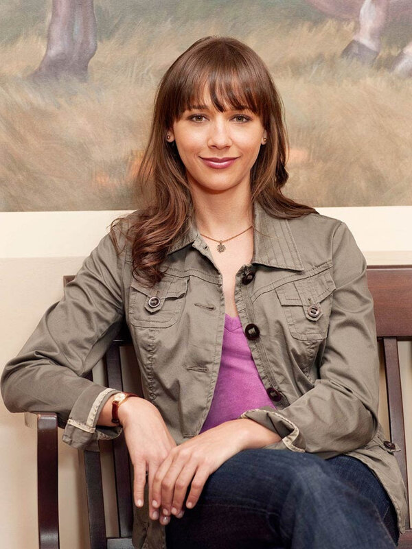 woman in green jacket sitting