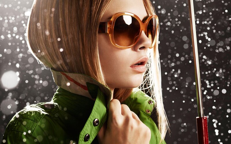 woman in green jacket with sunglasses
