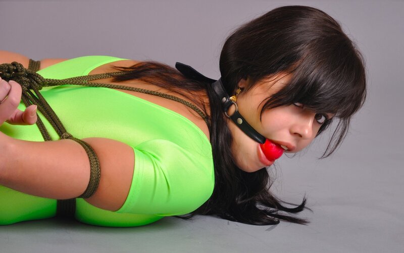woman in green outfit restrained