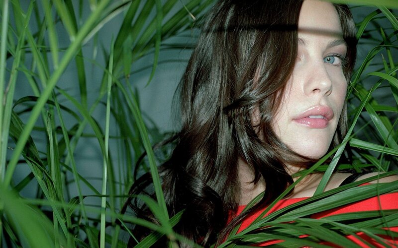 Woman in Green Plants — Dramatic