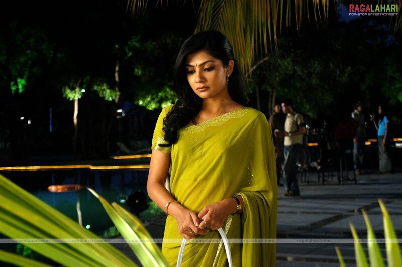 woman in green sari at night
