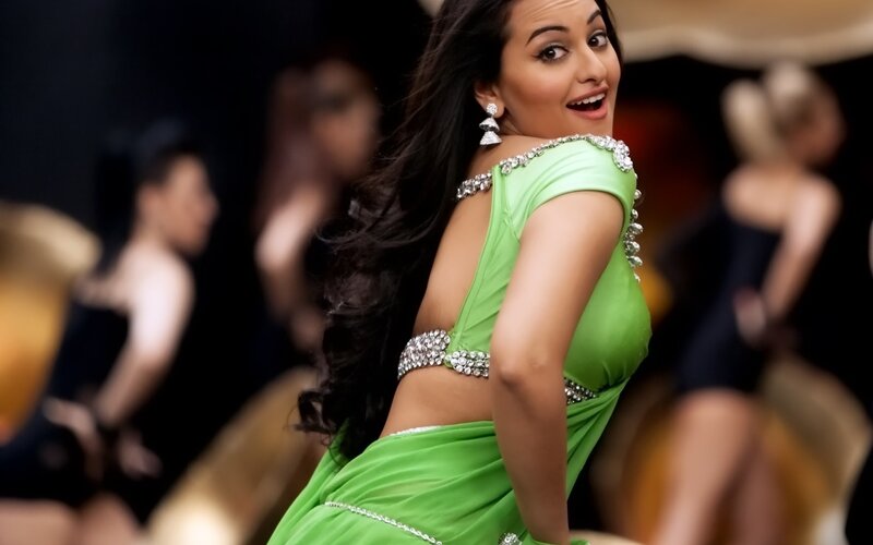 woman in green sari dancing