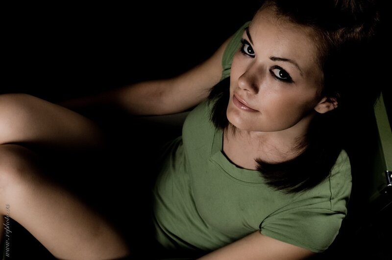 woman in green shirt looking at camera