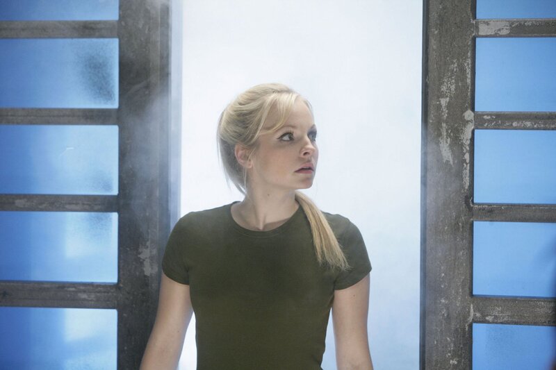 woman in green shirt looking up