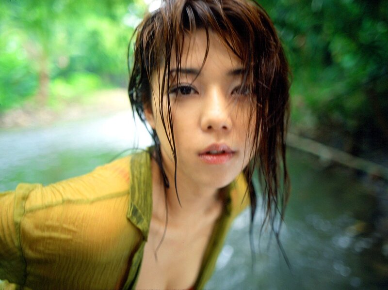 woman in green shirt near water