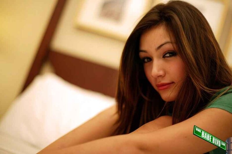 woman in green shirt on bed