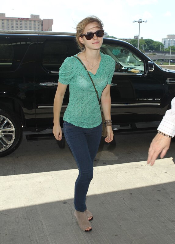 woman in green shirt walking
