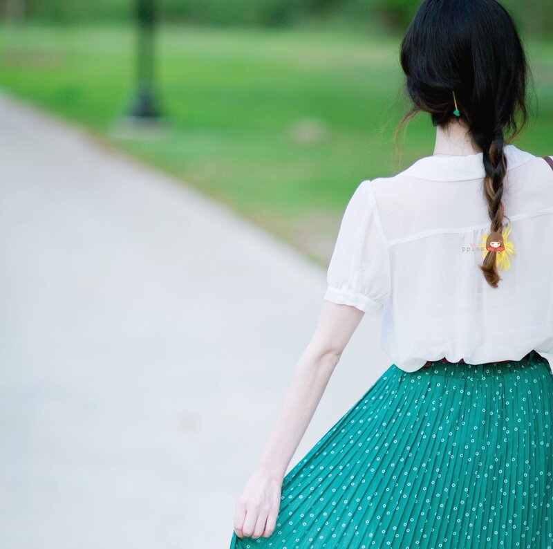 woman in green skirt walking