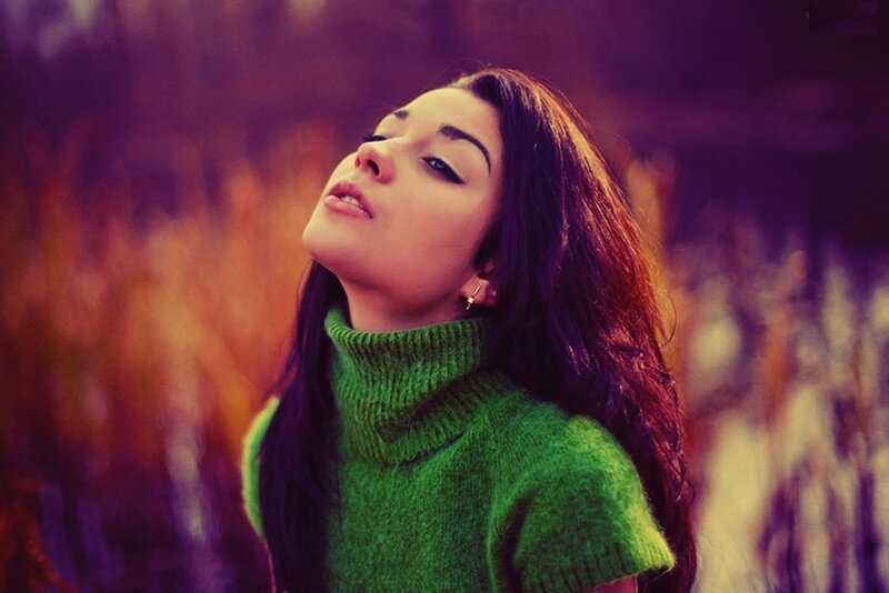woman in green sweater outdoors