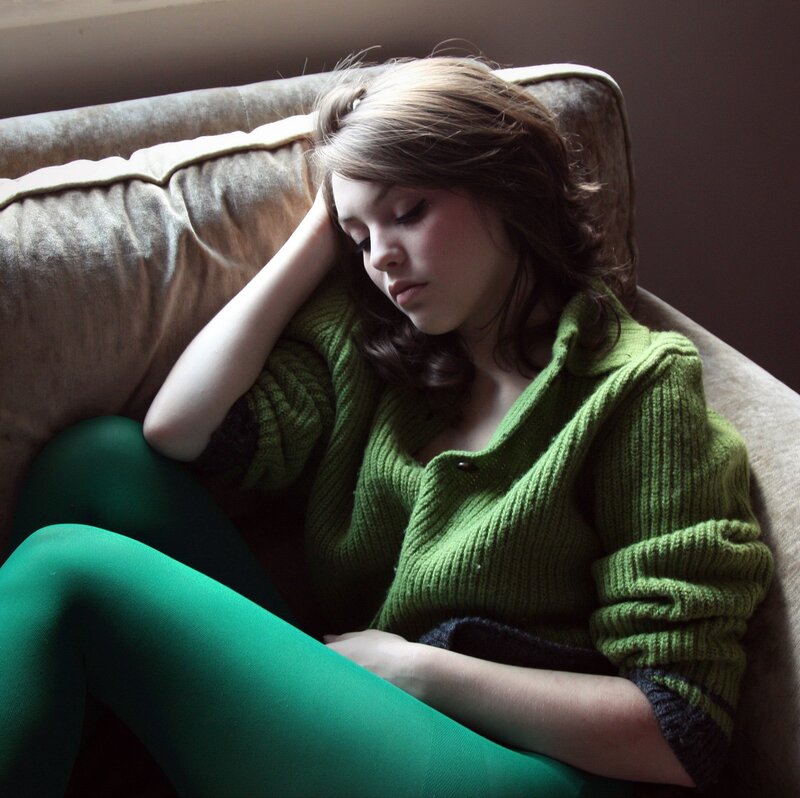 woman in green sweater resting
