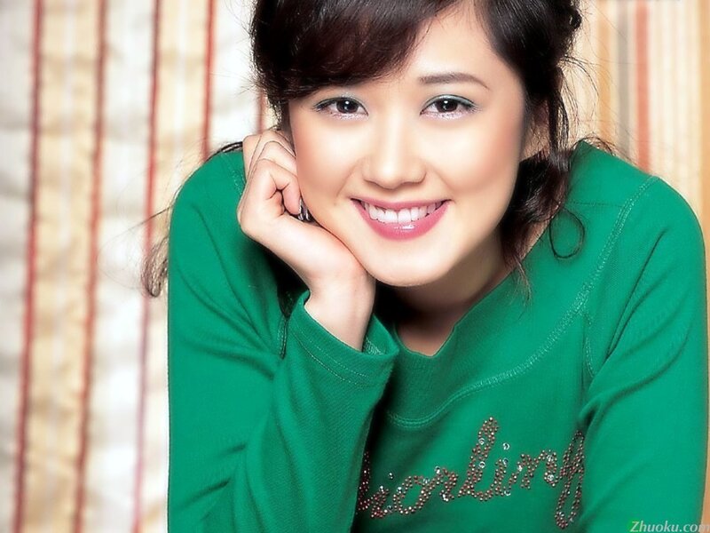 woman in green sweater smiling