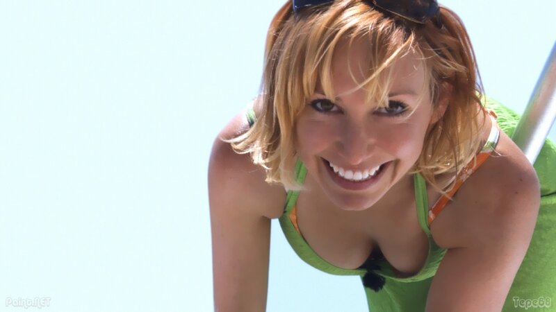 woman in green swimsuit smiling