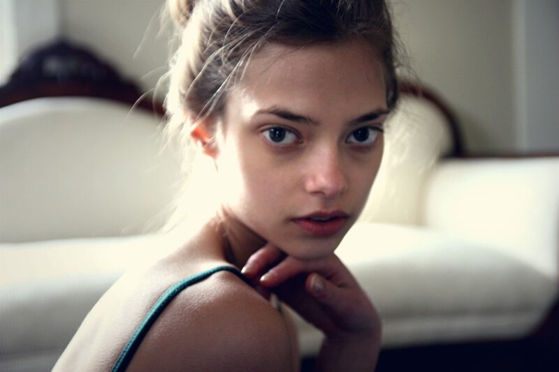 woman in green top looking at camera
