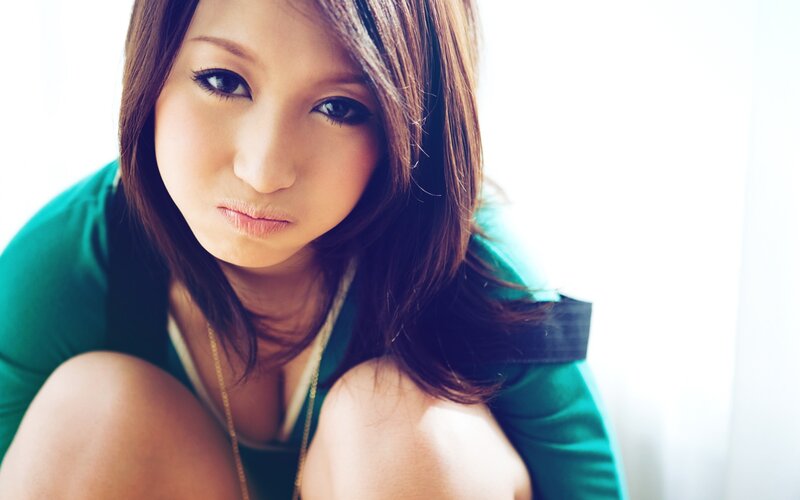 woman in green top looking at camera