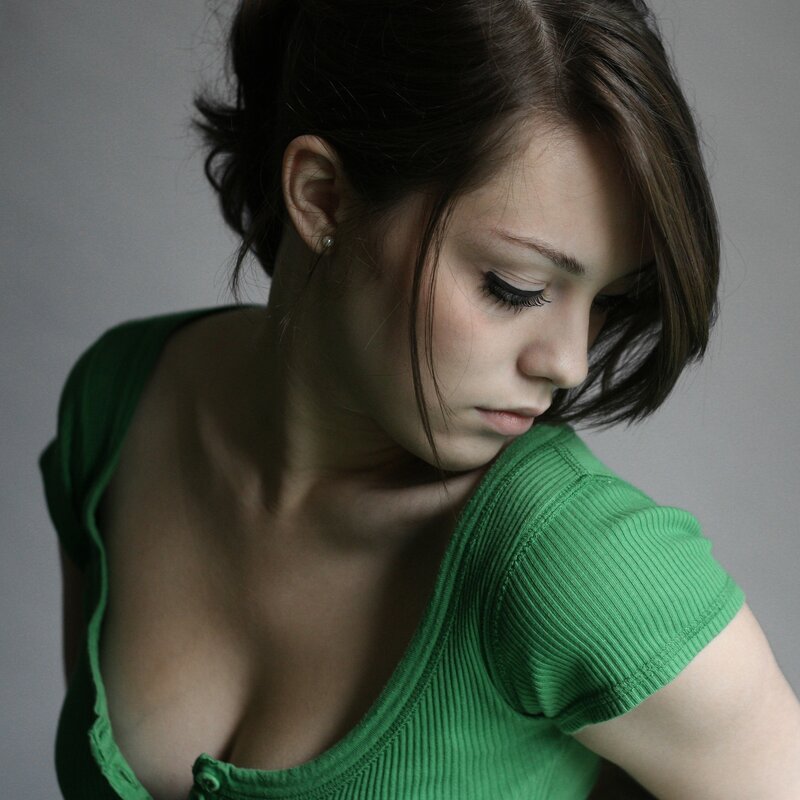 woman in green top looking down
