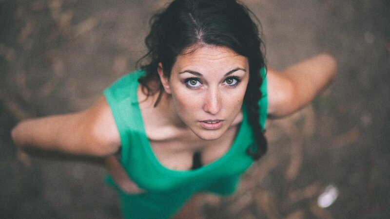 woman in green top looking up