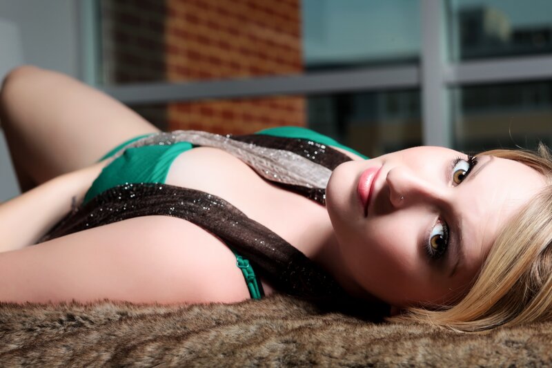woman in green top lying down