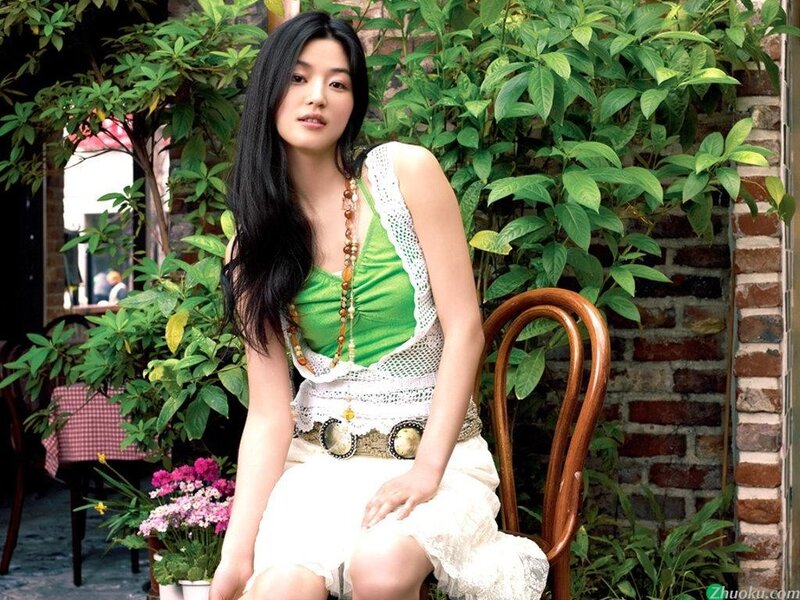 woman in green top sitting outdoors