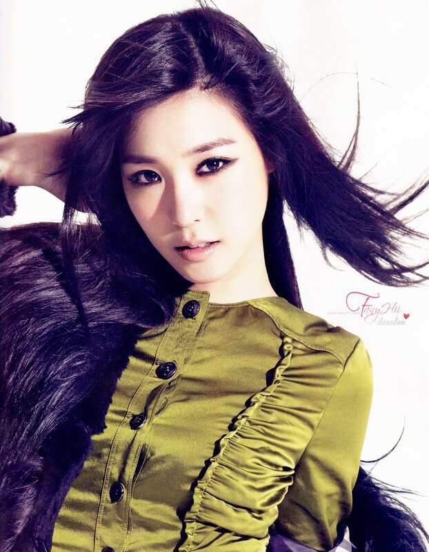 woman in green top with dark hair