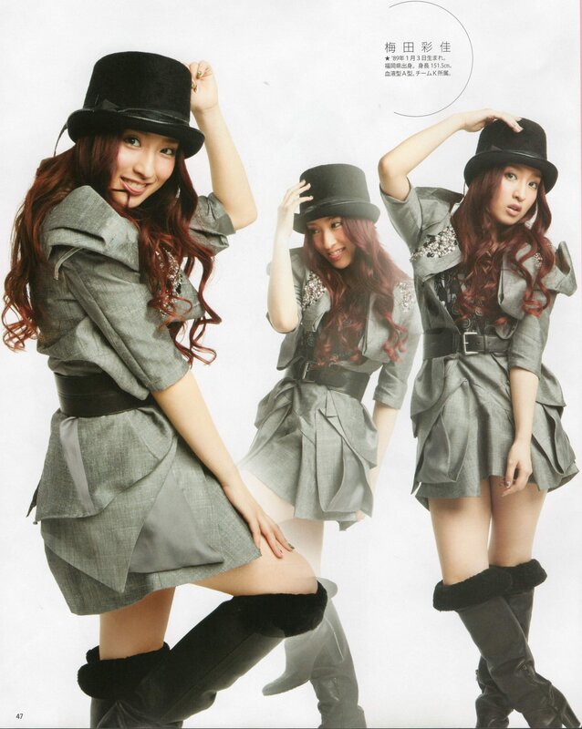 Woman in grey dress and hat