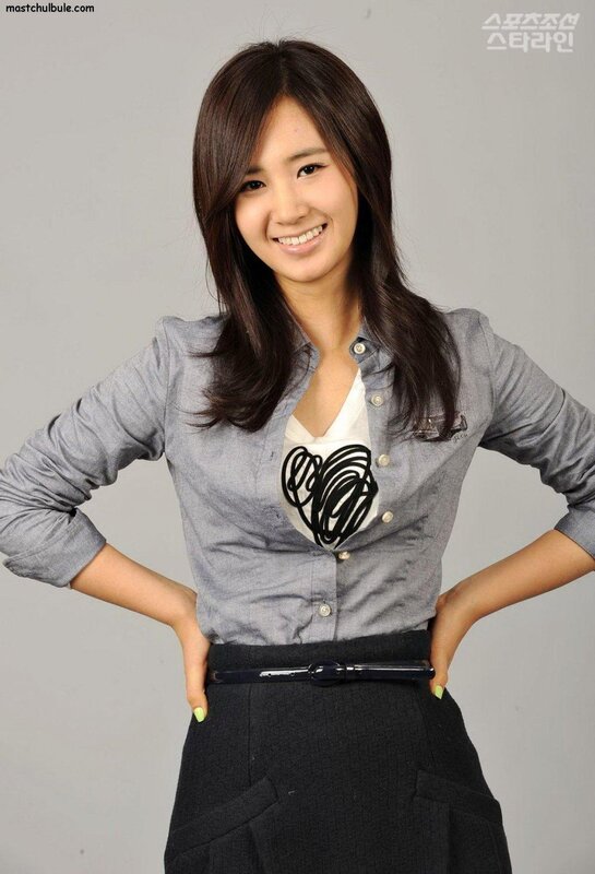 woman in grey shirt smiling