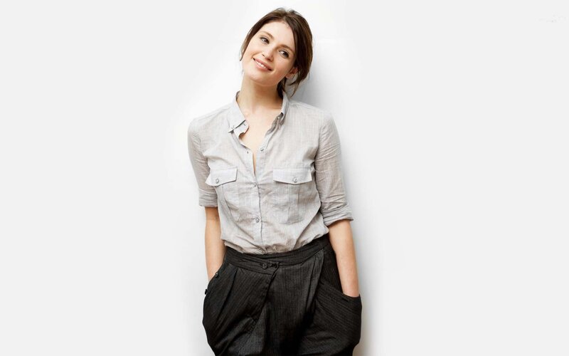 woman in grey shirt smiling