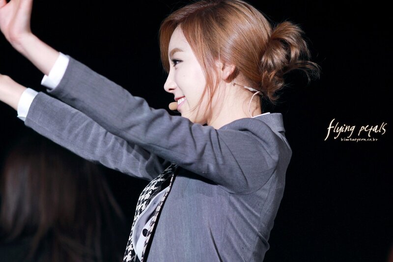 woman in grey suit on stage