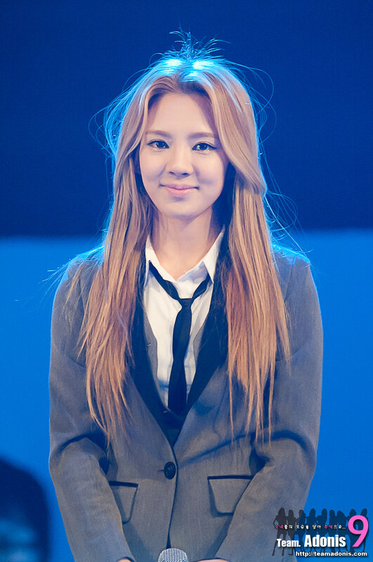 woman in grey suit smiling