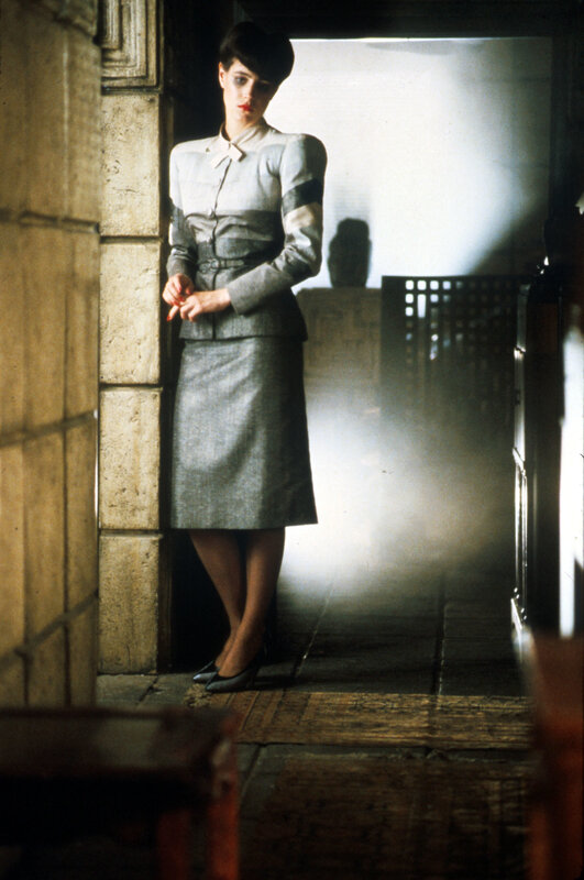 woman in grey suit standing